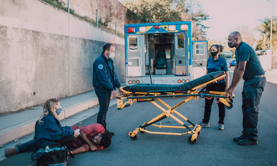 man on road with medics